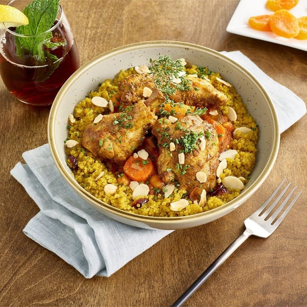 A Votre Santé's chicken and quinoa bowl with carrots, almonds, herbs, and iced tea.