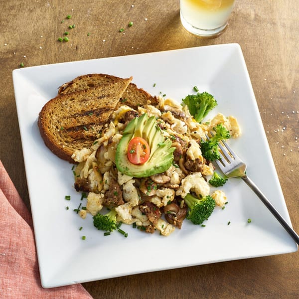 A Votre Santé's healthy scrambled eggs with avocado, tomato, broccoli, and toast.